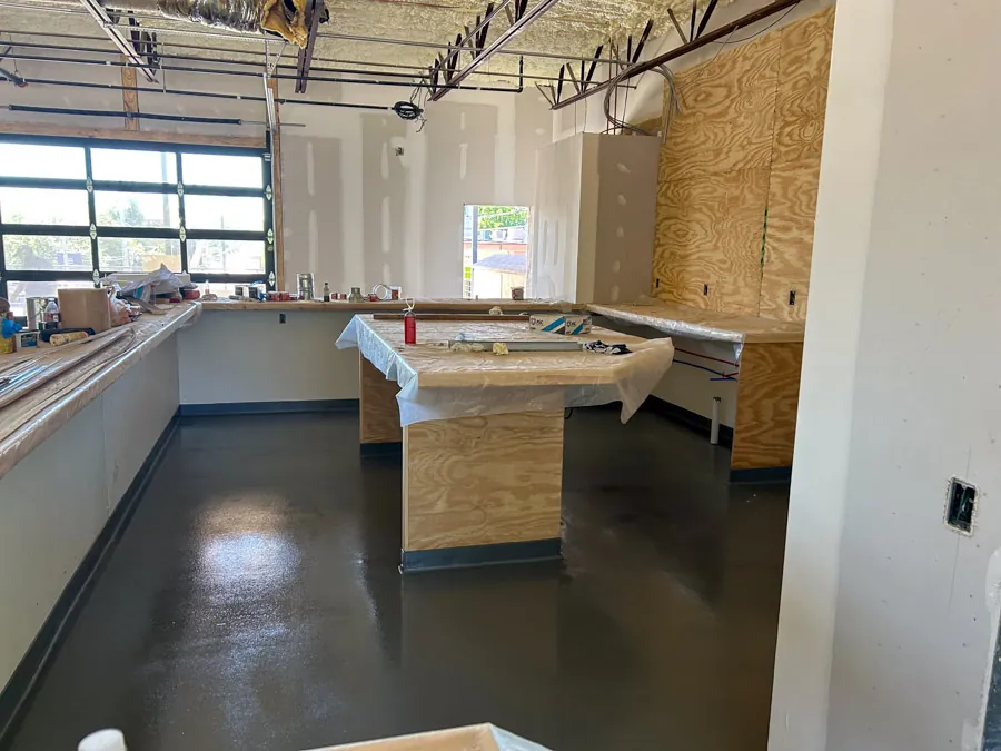 Glossy black epoxy floor in a commercial build-out, industrial flooring serving Nashville, TN