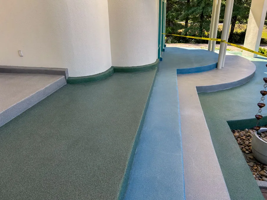 Curved coated concrete walkway with blue edging, commercial epoxy flooring serving Nashville, TN