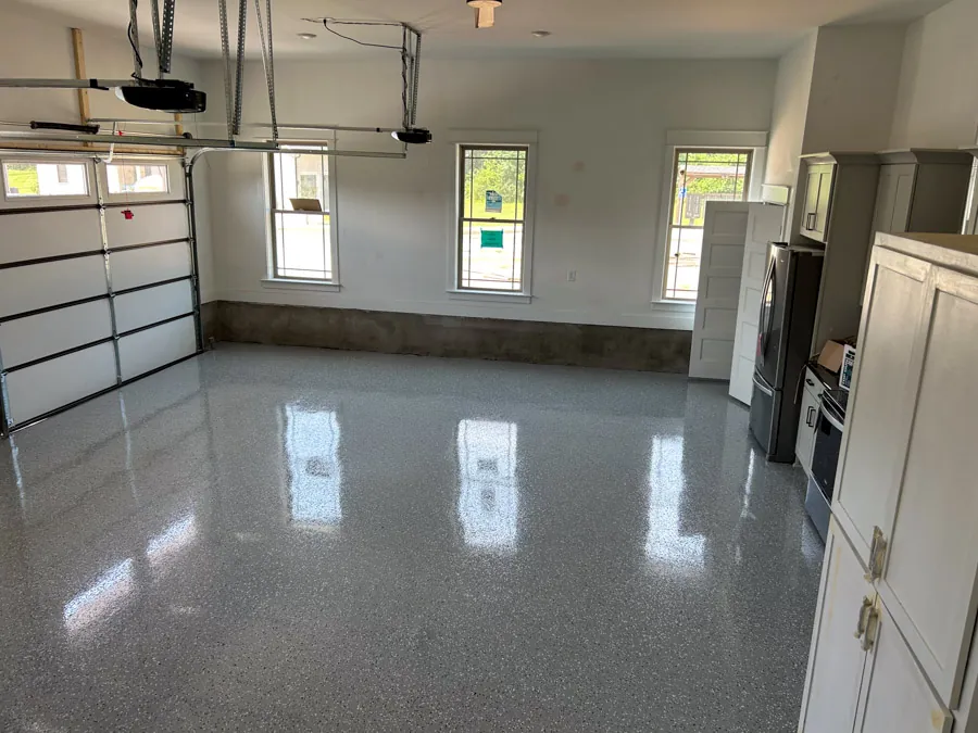 Glossy epoxy garage floor with storage cabinets, residential epoxy flooring serving Nashville, TN